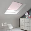 Room with white eaves wall, dark blue-grey wall to right with a shabby chic white drawer unit, a contemporary white chair, white painted floorboards and a skylight blind in pale coral.
