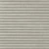 Pleated cellular window shade, light-gray textured fabric; fully lowered and closed, forming horizontal ridges; filtering diffuse interior light and obscuring any outside view.