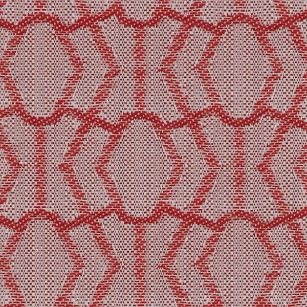 Woven fabric featuring repeating red geometric oval-and-hexagon motifs; lying flat and showing textured woven holes; close-up view with even lighting, suggesting upholstery or wallpaper.