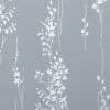 White, hand-drawn vertical floral-vine wallpaper covering a matte slate-blue wall, forming repeated slim columns of leaves and blossoms and creating a subtle vertical rhythm in soft, even light.